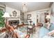 Elegant living room featuring a fireplace, chandelier, built-in shelving, and comfortable seating at 12 Innisfree Dr, Durham, NC 27707