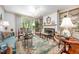 Elegant living room featuring a fireplace, chandelier, built-in shelving, and plush furnishings at 12 Innisfree Dr, Durham, NC 27707