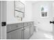 Beautiful bathroom with grey vanity, gold hardware and faucet, marble floors, and a modern mirror at 1222 Red Cedar Ct, Youngsville, NC 27596