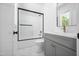 Modern bathroom features a vanity with gold hardware, framed mirror, and shower with glass doors at 1222 Red Cedar Ct, Youngsville, NC 27596