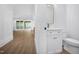 Bright bathroom featuring a modern vanity with a gold-framed mirror and sleek fixtures at 1222 Red Cedar Ct, Youngsville, NC 27596