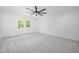 Spacious bedroom with a modern ceiling fan, carpeted floors, and plenty of natural light from the windows at 1222 Red Cedar Ct, Youngsville, NC 27596