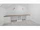 Close up of bright bonus room with built-in desk, shelves, and cabinet storage at 1222 Red Cedar Ct, Youngsville, NC 27596