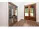 Entryway with wood-look floors and wood-framed glass doors that bring the outdoors in at 1222 Red Cedar Ct, Youngsville, NC 27596