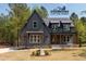 Stunning new construction shows a modern farmhouse exterior with gray siding and a landscaped front yard at 1222 Red Cedar Ct, Youngsville, NC 27596
