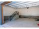 Spacious garage with concrete steps and a black railing leading to upper level at 1222 Red Cedar Ct, Youngsville, NC 27596