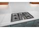 Close up on a kitchen featuring a gas cooktop and white countertops, complementing light blue cabinets at 1222 Red Cedar Ct, Youngsville, NC 27596
