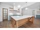 Modern kitchen featuring a large island, white countertops, and custom wood shelving at 1222 Red Cedar Ct, Youngsville, NC 27596