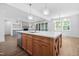 Bright kitchen features a large island with a stainless steel dishwasher and stylish pendant lighting at 1222 Red Cedar Ct, Youngsville, NC 27596
