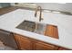 Kitchen island showcasing a stainless steel sink, cutting board, and modern faucet, complemented by wood cabinets at 1222 Red Cedar Ct, Youngsville, NC 27596
