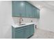 Laundry room with blue cabinets, white countertops, and a stainless steel sink at 1222 Red Cedar Ct, Youngsville, NC 27596