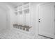 Mudroom with white lockers, a wooden bench, and marble flooring at 1222 Red Cedar Ct, Youngsville, NC 27596