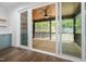 Screened patio features sliding glass doors, a ceiling fan, and a wooden ceiling at 1222 Red Cedar Ct, Youngsville, NC 27596