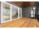 Screened patio with a wooden ceiling, ceiling fan, and views of the living room through sliding glass doors at 1222 Red Cedar Ct, Youngsville, NC 27596