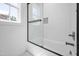 Clean shower and tub combo with glass doors, gray hardware, and white subway tile at 1222 Red Cedar Ct, Youngsville, NC 27596
