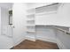 Bright walk-in closet with white shelving and wooden rods for ample storage space at 1222 Red Cedar Ct, Youngsville, NC 27596