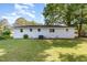 Spacious backyard showcases a neatly kept lawn and the home's crisp, white exterior with ample windows at 124 Strickland Dr, Smithfield, NC 27577