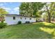 Expansive backyard featuring lush green grass and a well-maintained white brick home exterior at 124 Strickland Dr, Smithfield, NC 27577