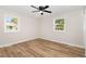 Bright bedroom with wood-look floors and two bright windows at 124 Strickland Dr, Smithfield, NC 27577