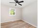 Bedroom featuring wood-look floors and a bright window at 124 Strickland Dr, Smithfield, NC 27577