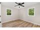 Bedroom featuring wood-look floors and two bright windows at 124 Strickland Dr, Smithfield, NC 27577