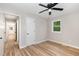 Bright bedroom with wood-look floors, ceiling fan, and a window with natural light at 124 Strickland Dr, Smithfield, NC 27577
