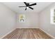 Empty bedroom showcasing modern vinyl floors, fresh paint, and a ceiling fan with a light at 124 Strickland Dr, Smithfield, NC 27577