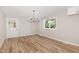 Bright dining room with new vinyl floors, updated lighting, fresh paint, and a large window at 124 Strickland Dr, Smithfield, NC 27577