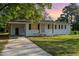 Inviting single-story home with a covered parking area, white brick, and neatly landscaped front yard at 124 Strickland Dr, Smithfield, NC 27577