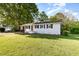 Well-kept single-story white brick home with a spacious front yard and charming curb appeal at 124 Strickland Dr, Smithfield, NC 27577