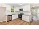 Modern kitchen featuring white cabinets, granite countertops, stainless steel appliances, and a stylish backsplash at 124 Strickland Dr, Smithfield, NC 27577