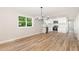 Open concept kitchen and dining area with modern appliances, granite countertops, and stylish vinyl floors at 124 Strickland Dr, Smithfield, NC 27577