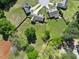 Aerial view of a home with a large backyard and fencing, surrounded by mature trees and landscaping at 1301 Tawny View Ln, Raleigh, NC 27603