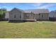 Exterior of a home featuring a wooden deck, a well-kept lawn, and a surrounding fence at 1301 Tawny View Ln, Raleigh, NC 27603