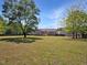 Large backyard featuring lush green lawn, a fenced perimeter, and mature trees, creating a private outdoor space at 1301 Tawny View Ln, Raleigh, NC 27603