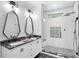 Modern bathroom with a double sink vanity, stylish mirrors, and glass enclosed shower at 1301 Tawny View Ln, Raleigh, NC 27603