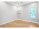 Bright bedroom with hardwood floors, a modern ceiling fan, and natural light from window at 1301 Tawny View Ln, Raleigh, NC 27603