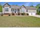 Charming single-story home with well-manicured lawn, two-car garage, and inviting front porch at 1301 Tawny View Ln, Raleigh, NC 27603