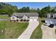 Charming home with manicured lawn, inviting front porch, and three-car garage at 1301 Tawny View Ln, Raleigh, NC 27603