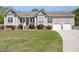 Charming single Gathering home with an attached two car garage, beautiful lawn, and mature landscaping at 1301 Tawny View Ln, Raleigh, NC 27603
