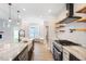 Open kitchen layout featuring a large island, stainless steel appliances, and dining area at 1301 Tawny View Ln, Raleigh, NC 27603
