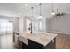 Spacious kitchen island featuring marble countertops, stainless steel dishwasher, and farmhouse sink at 1301 Tawny View Ln, Raleigh, NC 27603