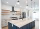 Modern kitchen with a large island, stainless steel appliances, and white subway tile at 1301 Tawny View Ln, Raleigh, NC 27603