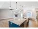 Modern open-concept kitchen featuring a spacious island and adjoining living area with fireplace at 1301 Tawny View Ln, Raleigh, NC 27603