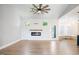 Modern living room featuring a decorative fireplace, hardwood flooring, and a back yard patio at 1301 Tawny View Ln, Raleigh, NC 27603