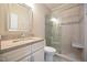 This bathroom has granite counters, decorative tile in the glass-enclosed shower, and neutral flooring at 14 Whit Ct, Angier, NC 27501