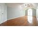 A large bedroom with hardwood floors, soft blue walls, and a ceiling fan at 14 Whit Ct, Angier, NC 27501