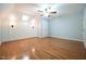 Hardwood floor bedroom has stylish wall trim, skylight, wall sconces, and a ceiling fan at 14 Whit Ct, Angier, NC 27501