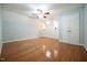 A sunlit bedroom with hardwood floors, wall sconces, a ceiling fan and natural light at 14 Whit Ct, Angier, NC 27501