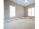 Neutral carpeted bedroom featuring a ceiling fan and two large windows letting in plenty of light at 14 Whit Ct, Angier, NC 27501